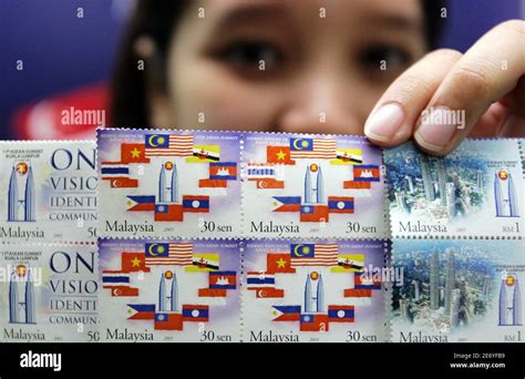 A Malaysian Postal Service Employee Shows A New Set Of Commemorative