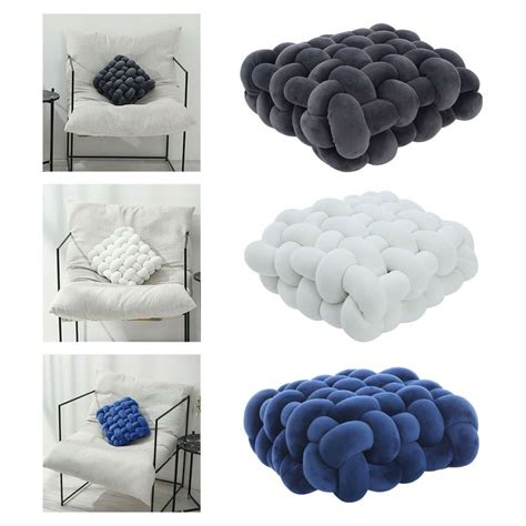 Four Different Types Of Pillows Sitting Next To Each Other On Top Of A