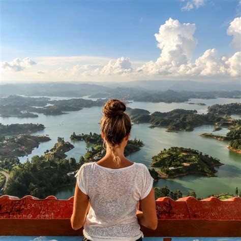 Female Tourist Admiring The Landscape From Atop Penol De Guatape The