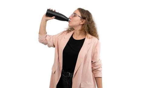 Premium Photo A Woman In A Suit Is Drinking From A Reusable Water