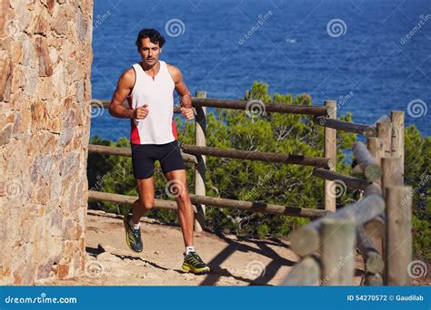 A Tall Man With A Sports Figure On Morning Jog In The Hills Near The