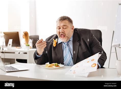 Overloaded Busy Businessman Having Lunch At Work Stock Photo Alamy