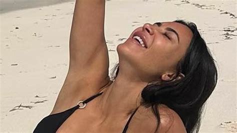 Kim Kardashian Shows Off Her Jaw Dropping Figure In A Busty Black Bikini As She Relaxes On The