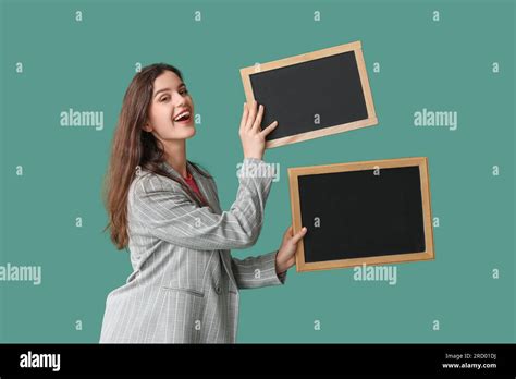 Female Teacher With Chalkboards On Green Background Stock Photo Alamy