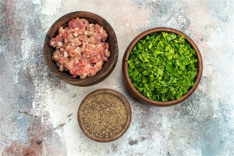 Free Photo Top View Bowls With Black Pepper Greens Meat On Nude Background