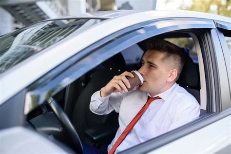 Premium Photo Businessman Drinking Coffee In The Car