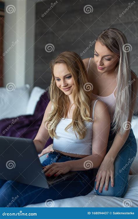 Young Domestic Lesbian Couple Using Laptop At Home Stock Image Image