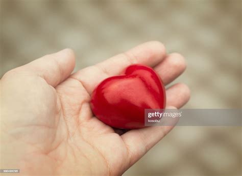 Young Woman Holds Out A Red Heart In Her Hand Concept Of Love High Res