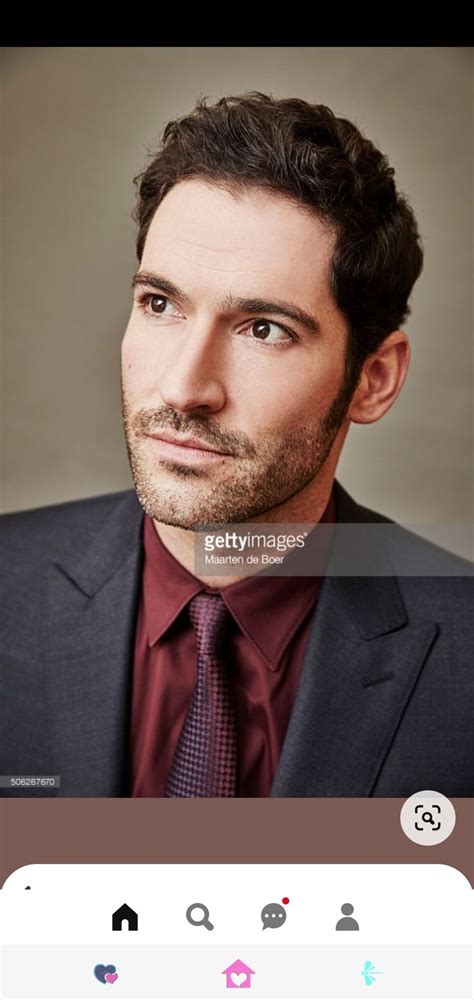 A Man In A Suit And Tie Looking At The Camera