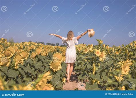 Beauty Sunlit Woman On Yellow Sunflower Field Freedom And Happiness