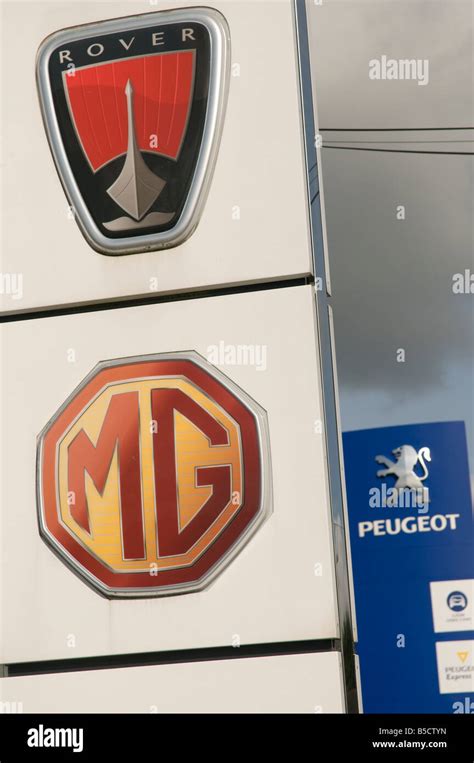 Rover Peugeot And Mg Car Makers Symbols On Garage Forecourt Stock Photo