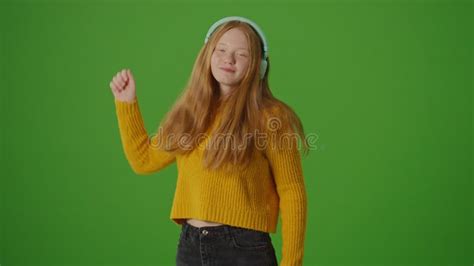 Green Screen Attractive Teenage Girl In Headphones Joyfully Dances