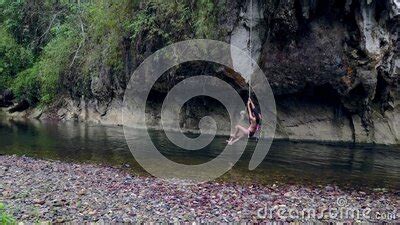 Cute Asian Girl In Bikini Playing On A Rope In The River Thailand Drone Stock Footage Video