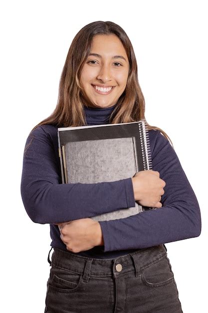 Retrato de una niña latina sonriente con libros aislado sobre fondo blanco Foto Premium