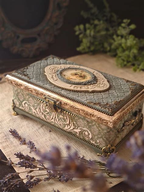 An Ornately Decorated Box Sitting On Top Of A Wooden Table Next To