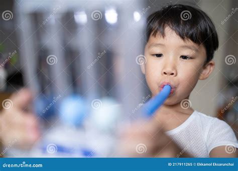 Thin Boy Uses A Tri Ball Incentive Spirometer For Check His Lung