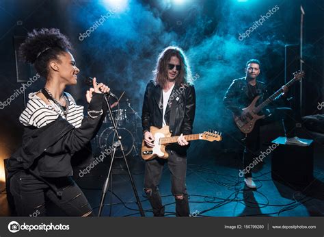 Rock band on stage — Stock Photo © TarasMalyarevich #150799280