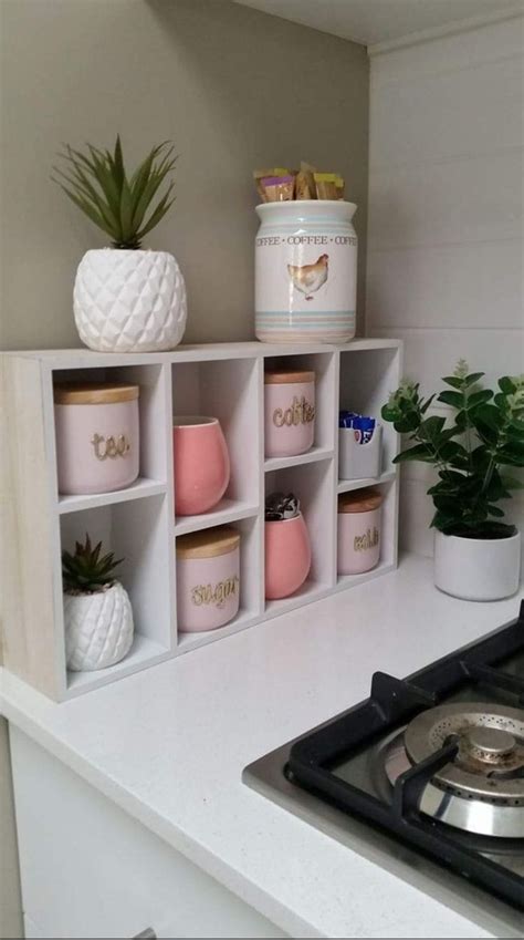 A Stove Top Oven Sitting Inside Of A Kitchen Next To A Potted Pineapple