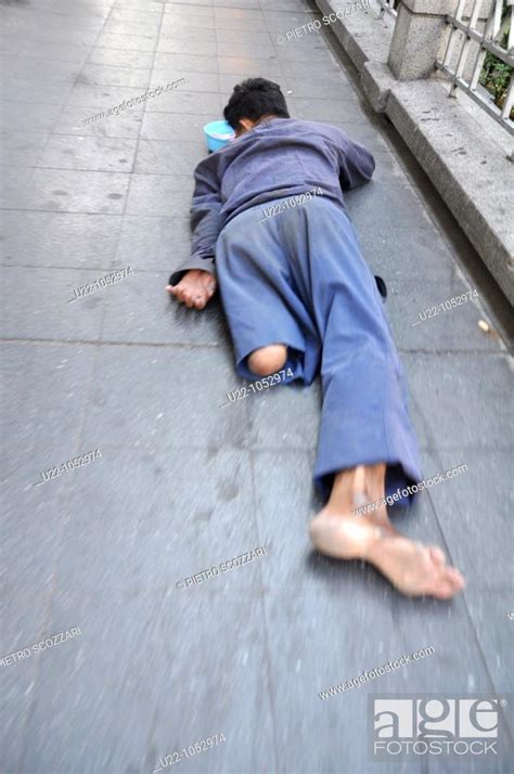 Bangkok Thailand A Beggar Lying On Sukhumvit Road Sidewalk Stock