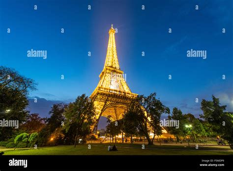 Illuminated Eiffel Tower At Dusk Tour Eiffel Champ De Mars Paris