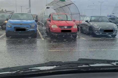 Asda Shopper Parks Car Under Trolley Shelter To Avoid Rain Storm