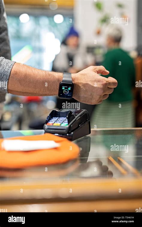 Customer Paying Contactless With His Smartwatch Stock Photo Alamy