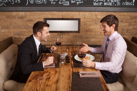 Two Friends Sitting In Cafe And Eating Lunch Stock Photo Image Of