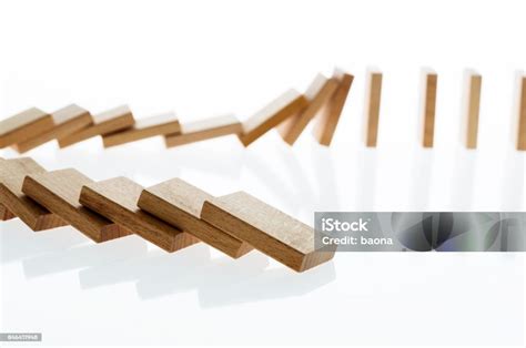 A Row Of Wooden Dominos Falling Down Stock Photo Download Image Now