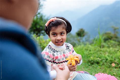 «Cute Little Girl With Flower Smiling» del colaborador de Stocksy ...