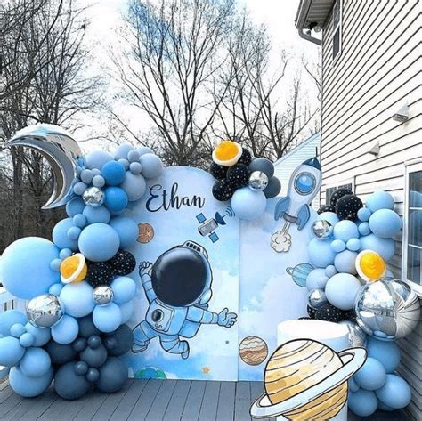 An Outdoor Space Themed Birthday Party With Balloon Decorations And