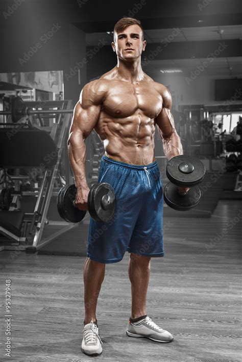 Muscular Man Working Out In Gym Doing Exercises With Barbell Strong Male Naked Torso Abs Foto