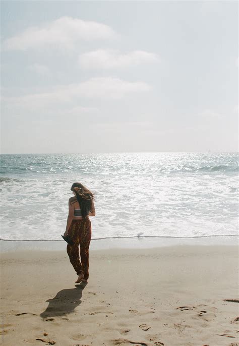 Teenager Walking Along California Beach By Stocksy Contributor Tana Teel Stocksy