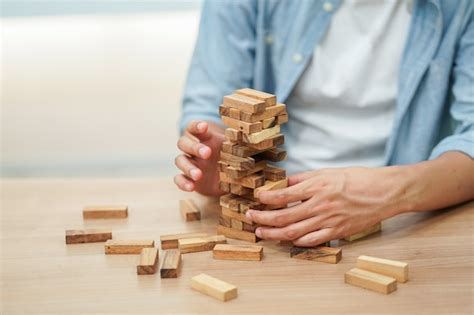 Premium Photo Close Up Employee Man Hand Holding Wooden Block For