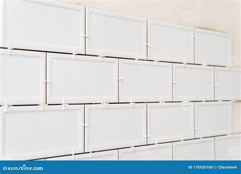 Unfinished White Ceramic Tiles With Tile Spacers Concept Of A Kitchen