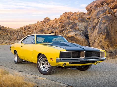 1969 Dodge Charger Yellow And Black 34 Front View On Pavement By Rocks