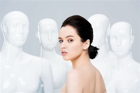 Naked Girl Looking At Camera While Posing Near Mannequins Isolated On Grey Stock Image Image