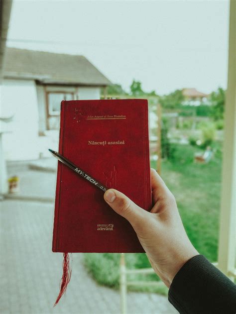 Person holding hardcover book with blank cover · Free Stock Photo