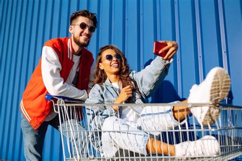 Premium Photo Stylish Man And Woman Having Fun And Riding Shopping