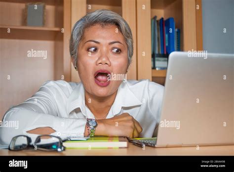 Attractive Desperate And Stressed Middle Aged Asian Woman Screaming