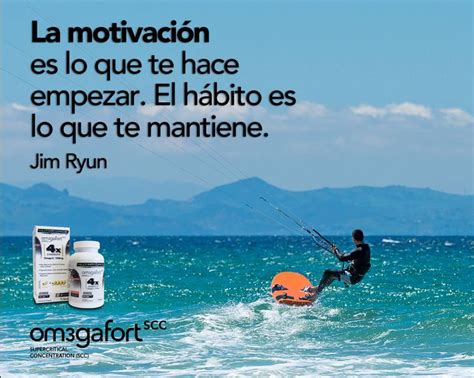 A Man Riding A Surfboard On Top Of The Ocean Next To An Orange Life