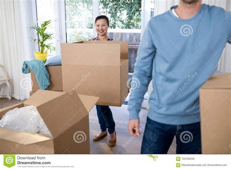 Couple Carrying Big Cardboard Box At New Home Stock Image Image Of