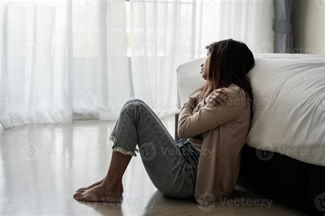 Lonely young woman feeling depressed and stressed sitting in the dark ...