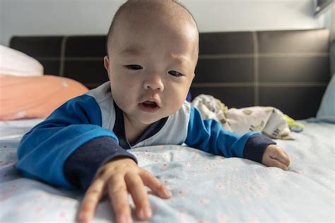 Premium Photo Portrait Of Cute Baby Lying On Sofa