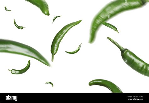 Green Chili Peppers Falling On White Background Stock Photo Alamy