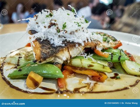 Fried Fish Fillet On Fresh Vegetables Served On A Plate Stock Image