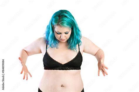 Fat girl. Upset overweight young woman looking at her fat midriff ...