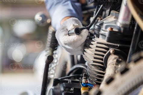 Mechanic Check Motorcycle Spark Plug In Workshop Garage Man Fixing