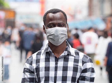 Foto De One Black African Man Wear Face Mask Looking At Camera Smile In The Eye At Urban Street