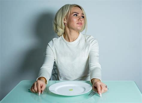 Anorexic Blonde Sits At The Table And Eats Stock Image Image Of Hunger Knife