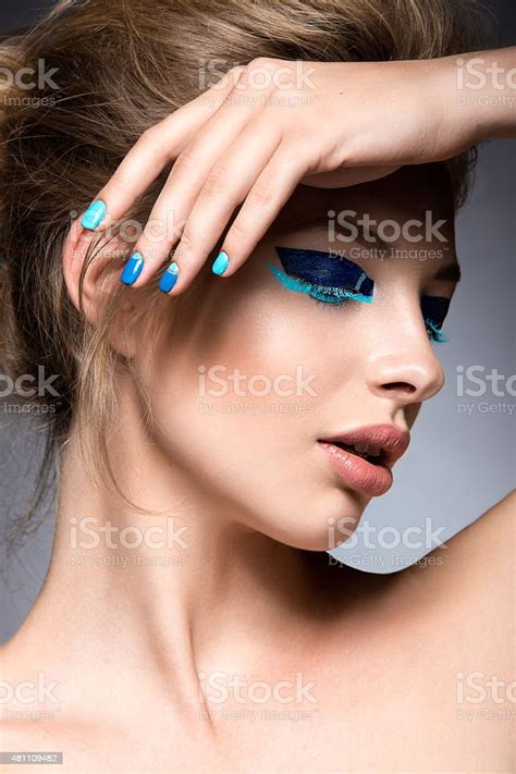 Beautiful Girl With Bright Creative Fashion Makeup And Blue Nail Stock